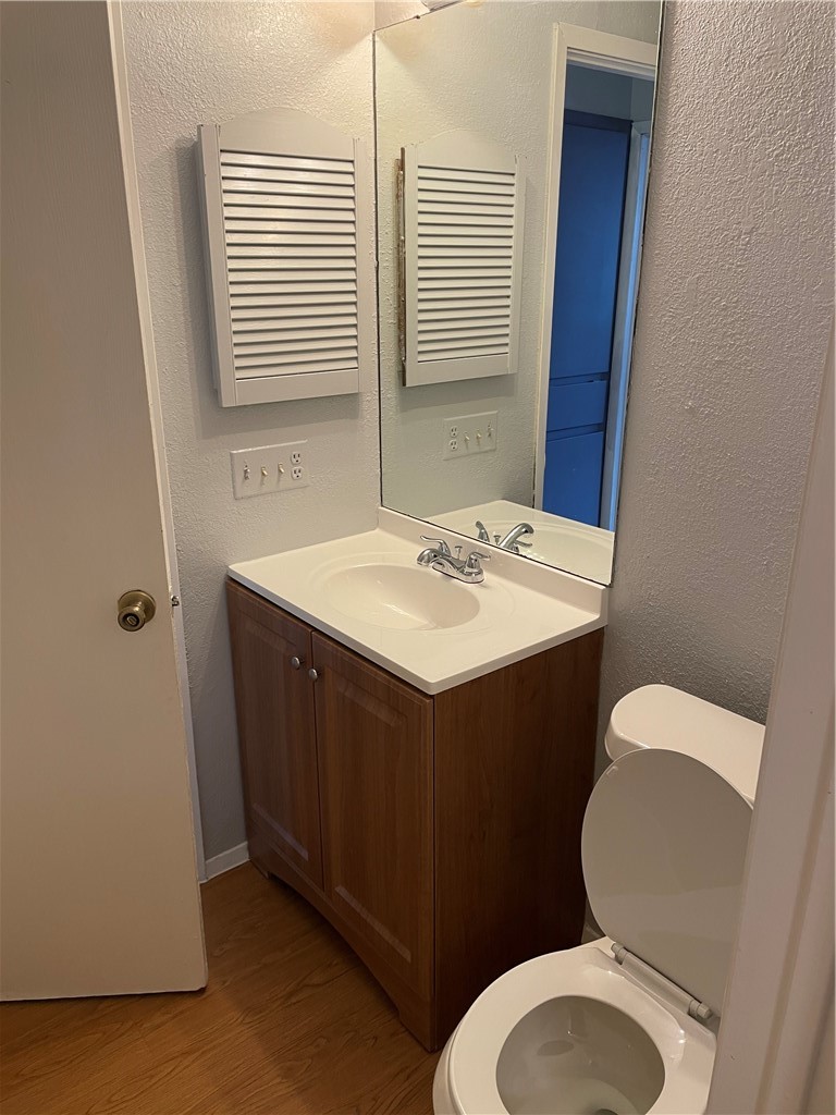 105 Meteor Drive, Unit A Austin, TX 78745 - Photo 18 of 23 a bathroom with a sink toilet and mirror