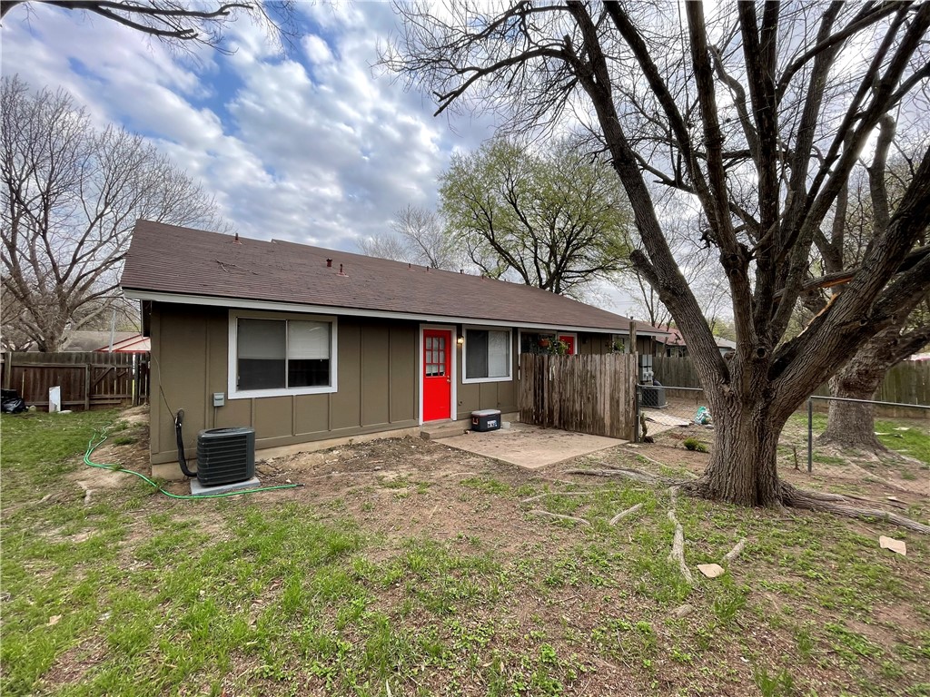 105 Meteor Drive, Unit A Austin, TX 78745 - Photo 22 of 23 a front view of a house with a yard and trees