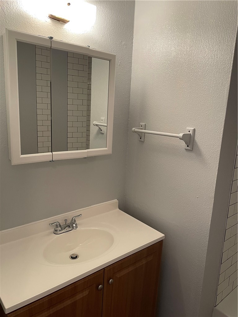 105 Meteor Drive, Unit A Austin, TX 78745 - Photo 5 of 23 a bathroom with a sink and a mirror