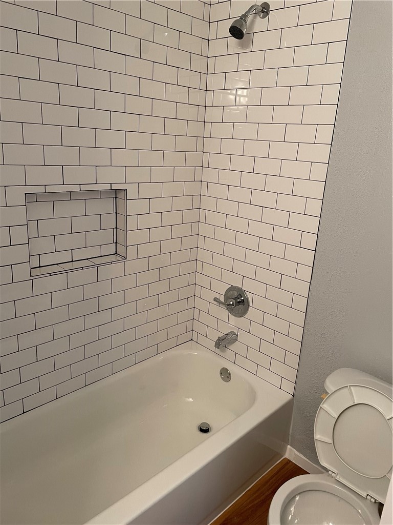 105 Meteor Drive, Unit A Austin, TX 78745 - Photo 6 of 23 a bathroom with a bathtub and toilet