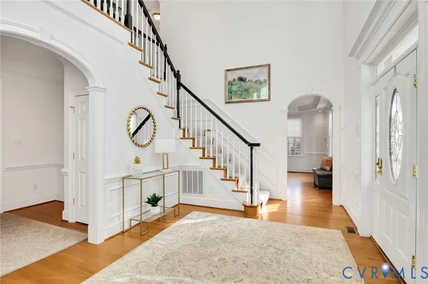 a view of entryway and hall with wooden floor