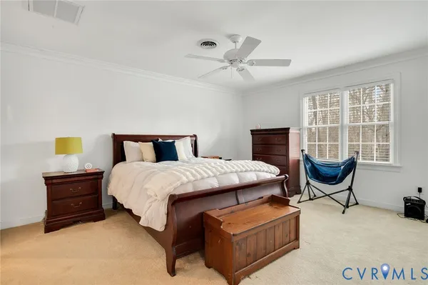 a bedroom with a bed and chair