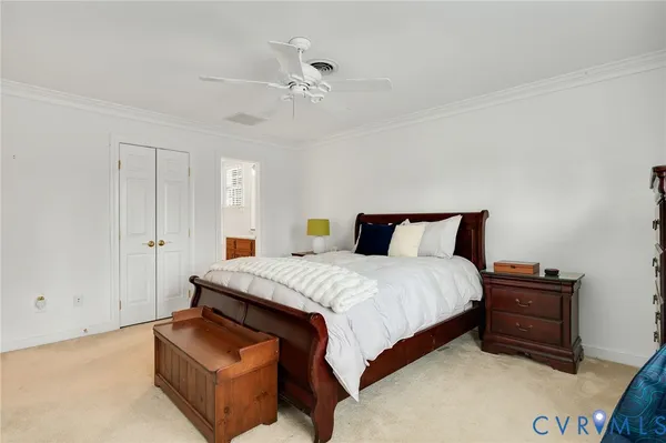 a spacious bedroom with a bed and a chandelier