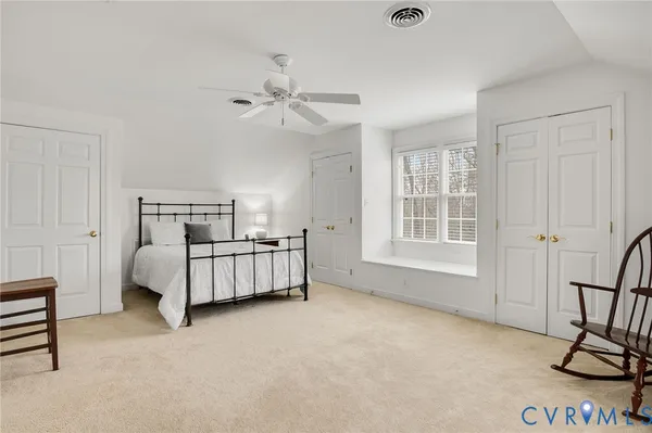 a bedroom with a bed and cabinets