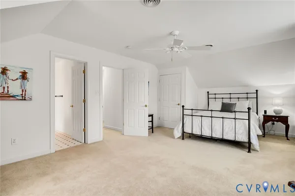 a view of a bedroom with furniture and window