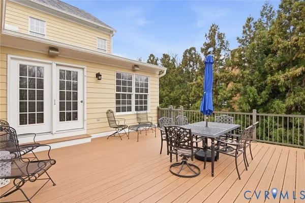 a view of a balcony with chairs and wooden floor