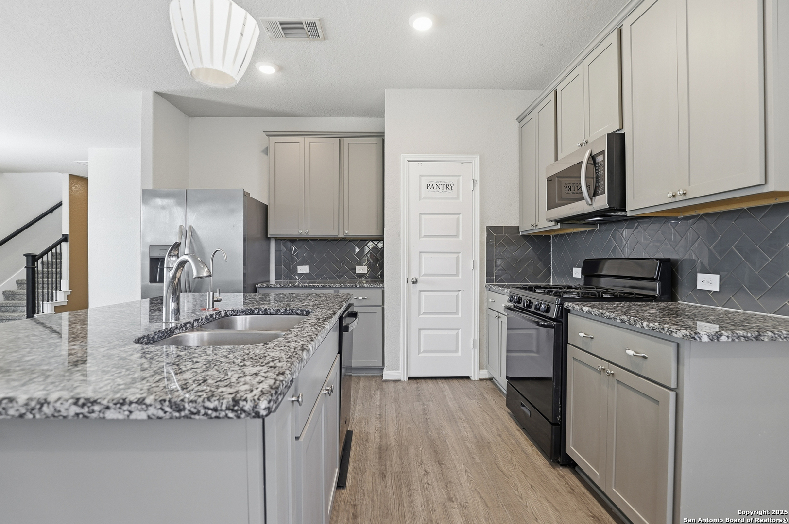 5002 Longhorn Converse, TX 78109 - Photo 11 of 36 a kitchen with stainless steel appliances granite countertop a sink stove and refrigerator
