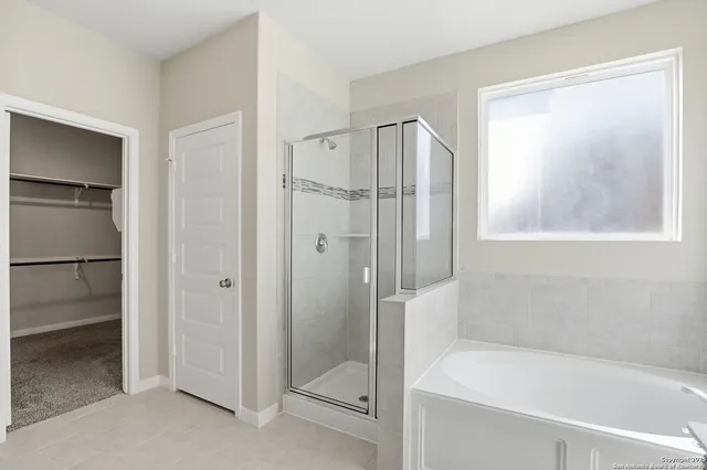 a bathroom with a bathtub and a shower