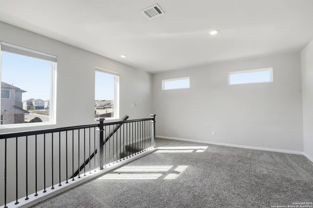 a view of a hallway with windows