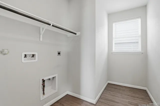 a view of room with window and wooden floor