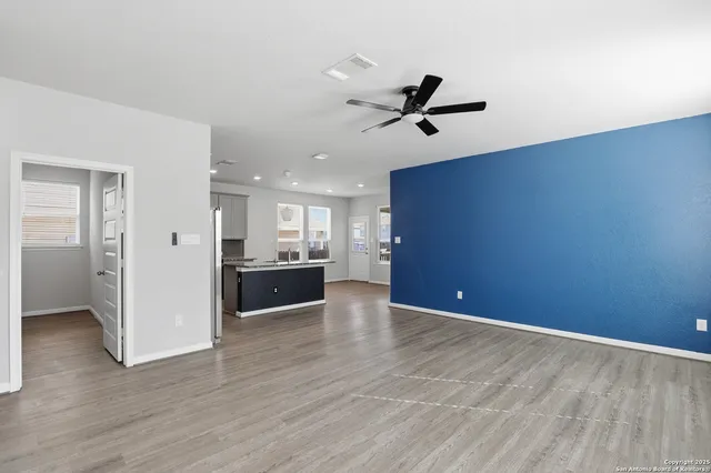 a view of a kitchen and an empty room