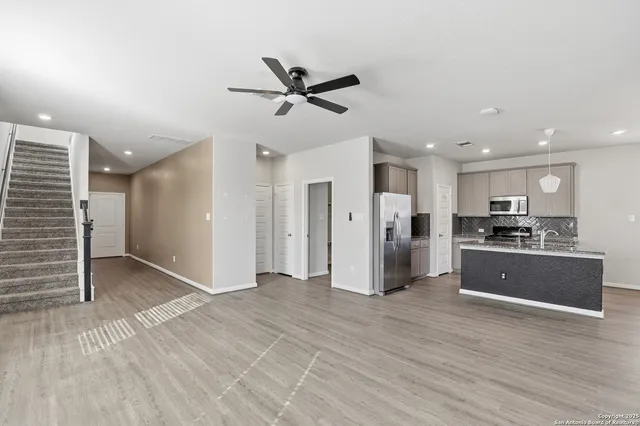 a view of a kitchen with a sink and a refrigerator