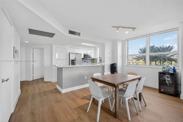 a kitchen with stainless steel appliances a sink a stove and a refrigerator