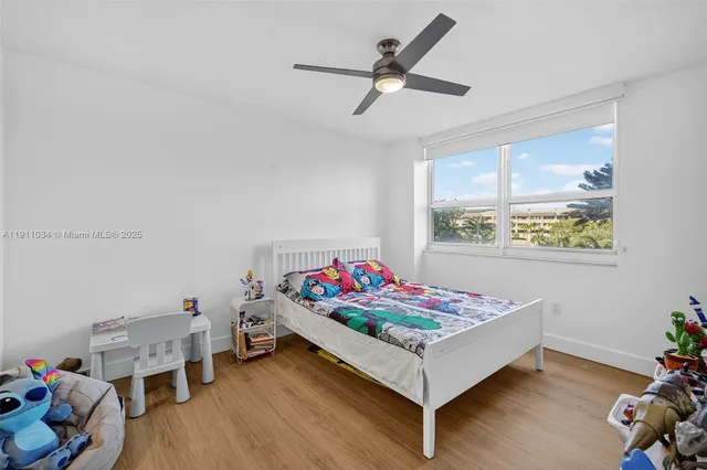 a view of an empty room with glass door and windows