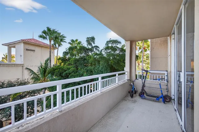 a view of a patio with table and chairs potted plants and palm trees