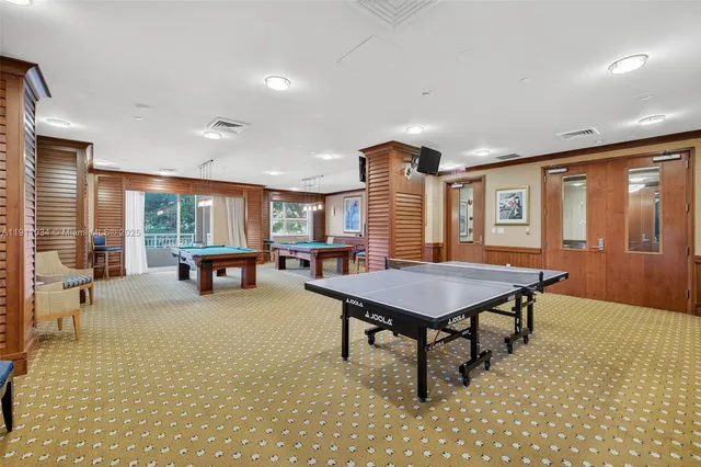 a view of a patio with table and chairs a barbeque with wooden fence and floor