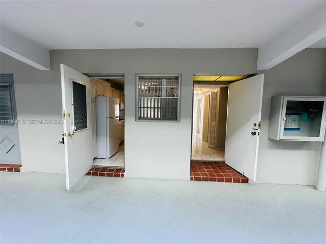 an empty room with a fireplace and windows