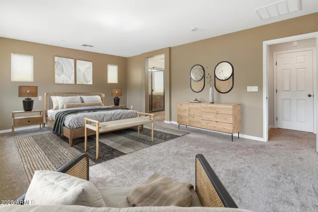 a bedroom with a bed and dresser with mirror