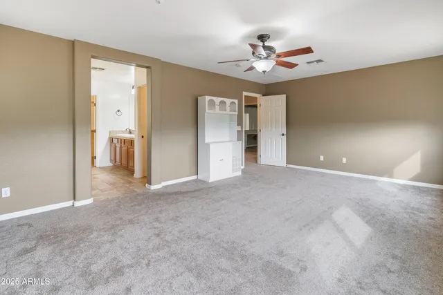 a view of a livingroom with a ceiling fan and window
