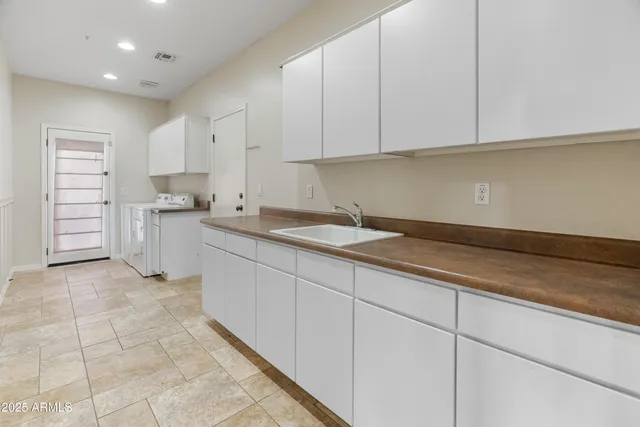 a kitchen with stainless steel appliances granite countertop a sink and cabinets