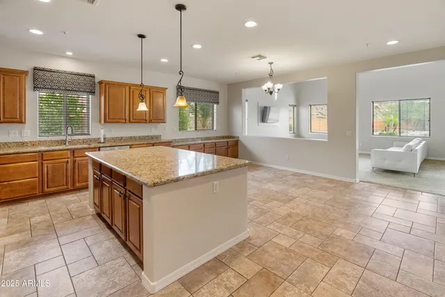 a kitchen with stainless steel appliances granite countertop a sink and a stove