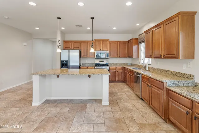 a large kitchen with stainless steel appliances lots of counter top space