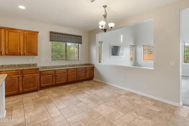 a large white kitchen with a sink and cabinets