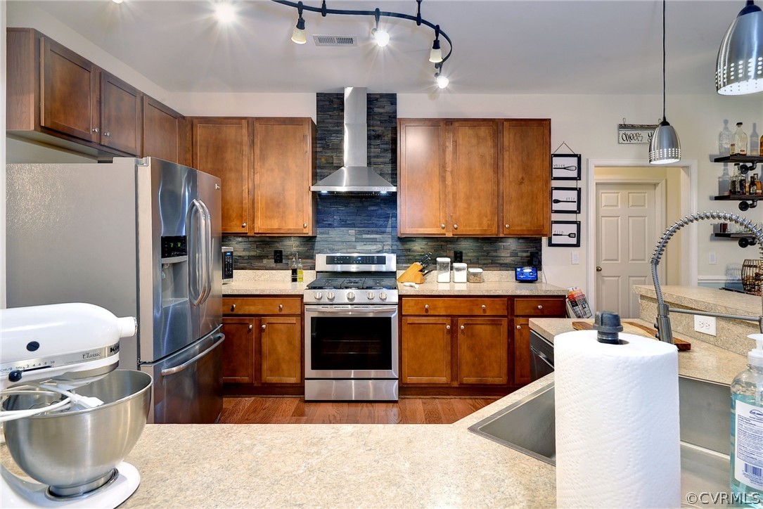 8343 Patrick Henry Way Gloucester, VA 23061 - Photo 11 of 39 a kitchen with stainless steel appliances kitchen island granite countertop a sink stove and refrigerator