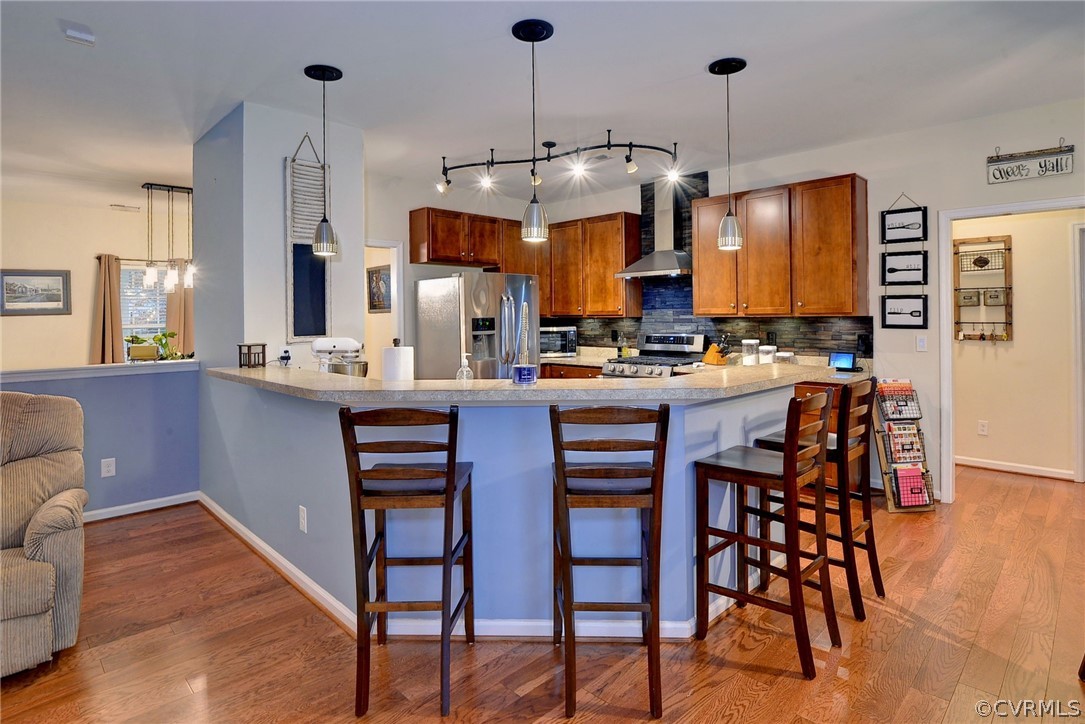 8343 Patrick Henry Way Gloucester, VA 23061 - Photo 12 of 39 a kitchen with a dining table chairs sink and cabinets