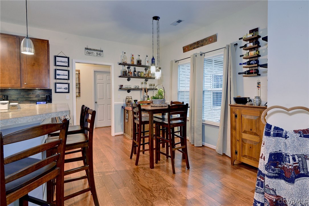 8343 Patrick Henry Way Gloucester, VA 23061 - Photo 13 of 39 a view of a dining room with furniture and wooden floor