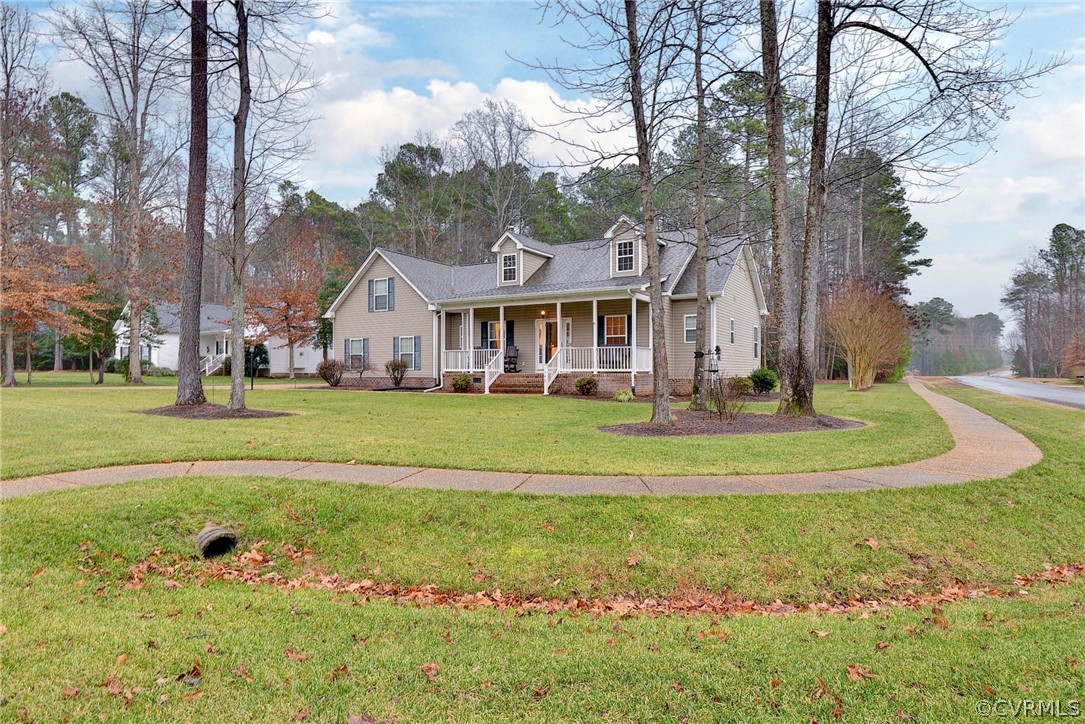 8343 Patrick Henry Way Gloucester, VA 23061 - Photo 2 of 39 a front view of a house with a yard