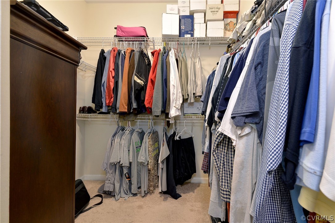 8343 Patrick Henry Way Gloucester, VA 23061 - Photo 25 of 39 a view of walk in closet with clothes and shoes