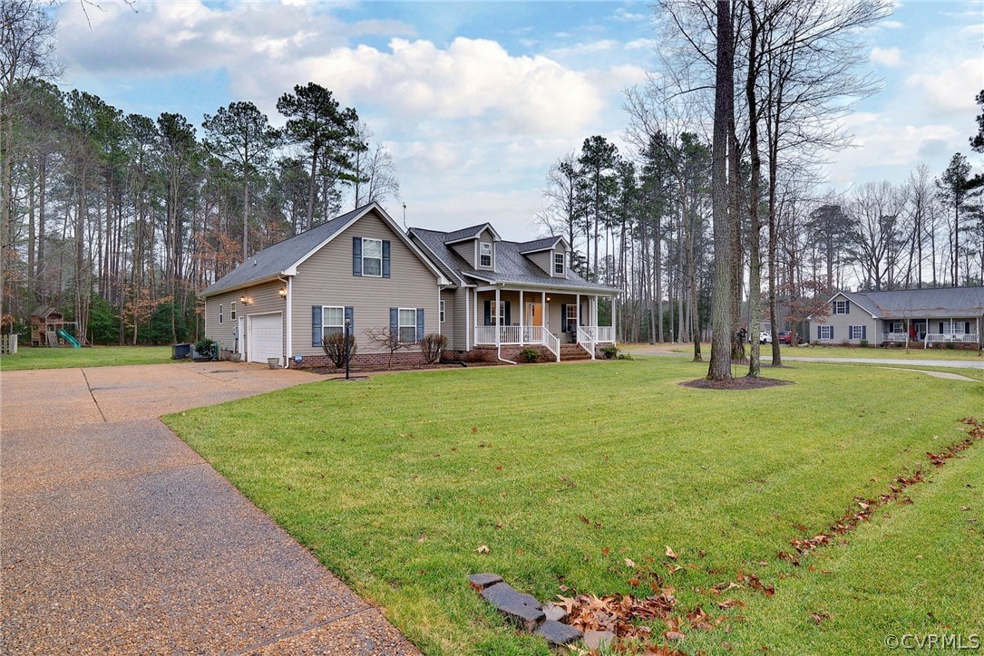 8343 Patrick Henry Way Gloucester, VA 23061 - Photo 3 of 39 a view of house with a garden