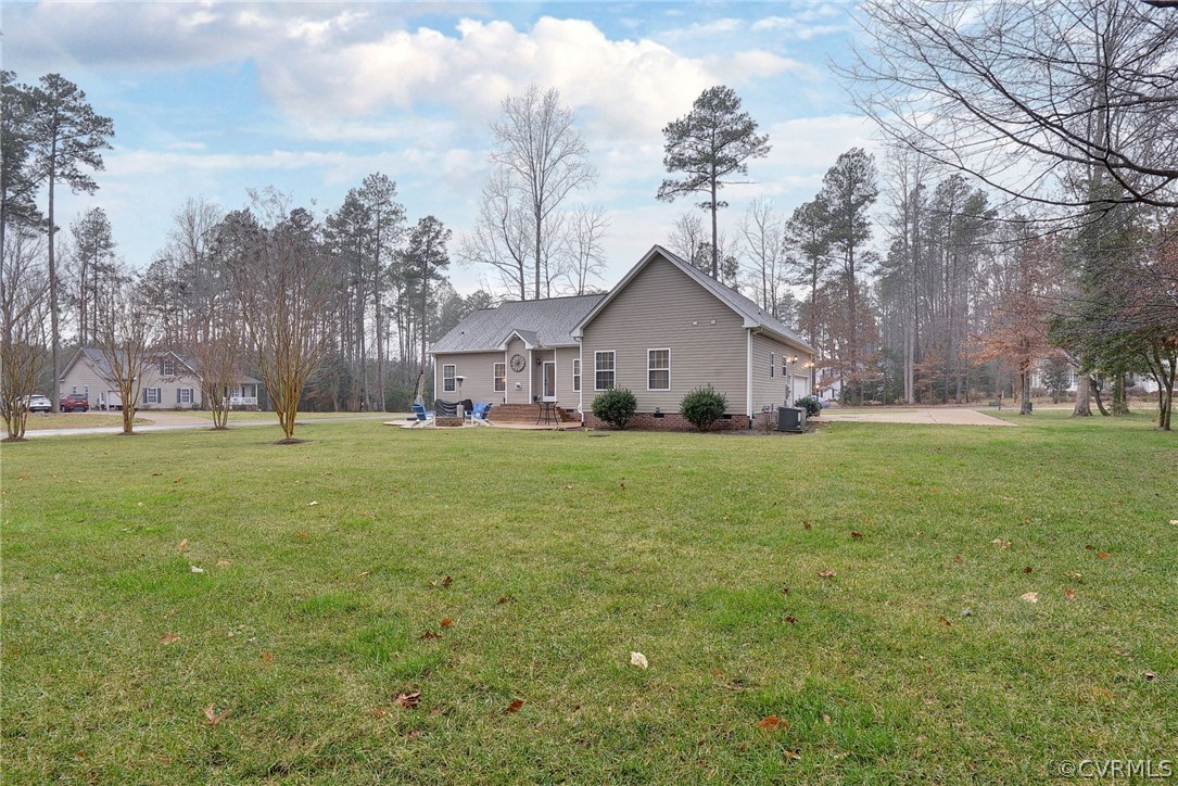 8343 Patrick Henry Way Gloucester, VA 23061 - Photo 37 of 39 a white house with a big yard and large trees