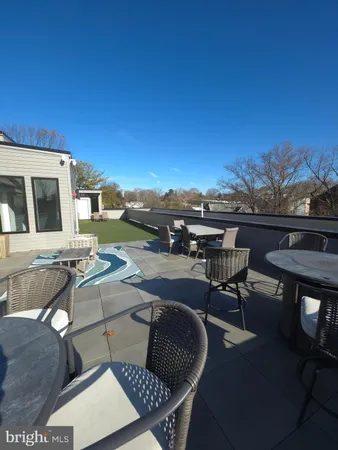 a terrace of a house with outdoor seating
