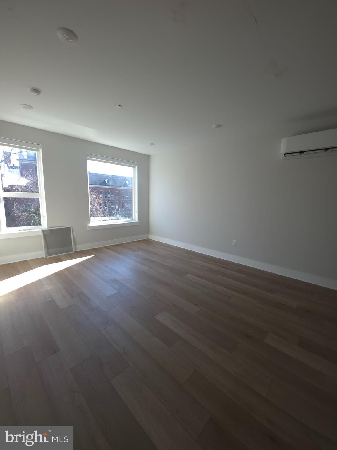 3503 Midvale Avenue, Unit 506 Philadelphia, PA 19129 - Photo 31 of 40 an empty room with wooden floor and windows
