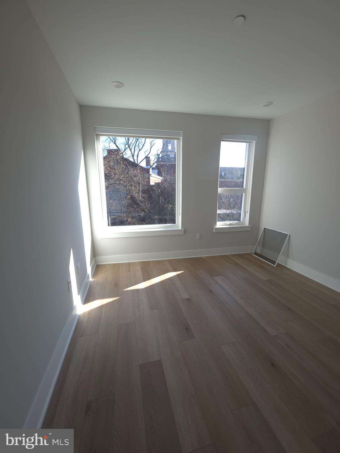 3503 Midvale Avenue, Unit 506 Philadelphia, PA 19129 - Photo 33 of 40 an empty room with wooden floor and windows