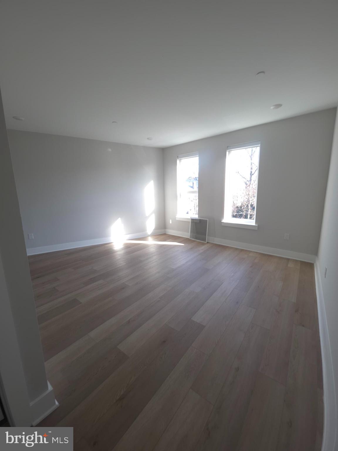 3503 Midvale Avenue, Unit 506 Philadelphia, PA 19129 - Photo 35 of 40 an empty room with wooden floor and windows