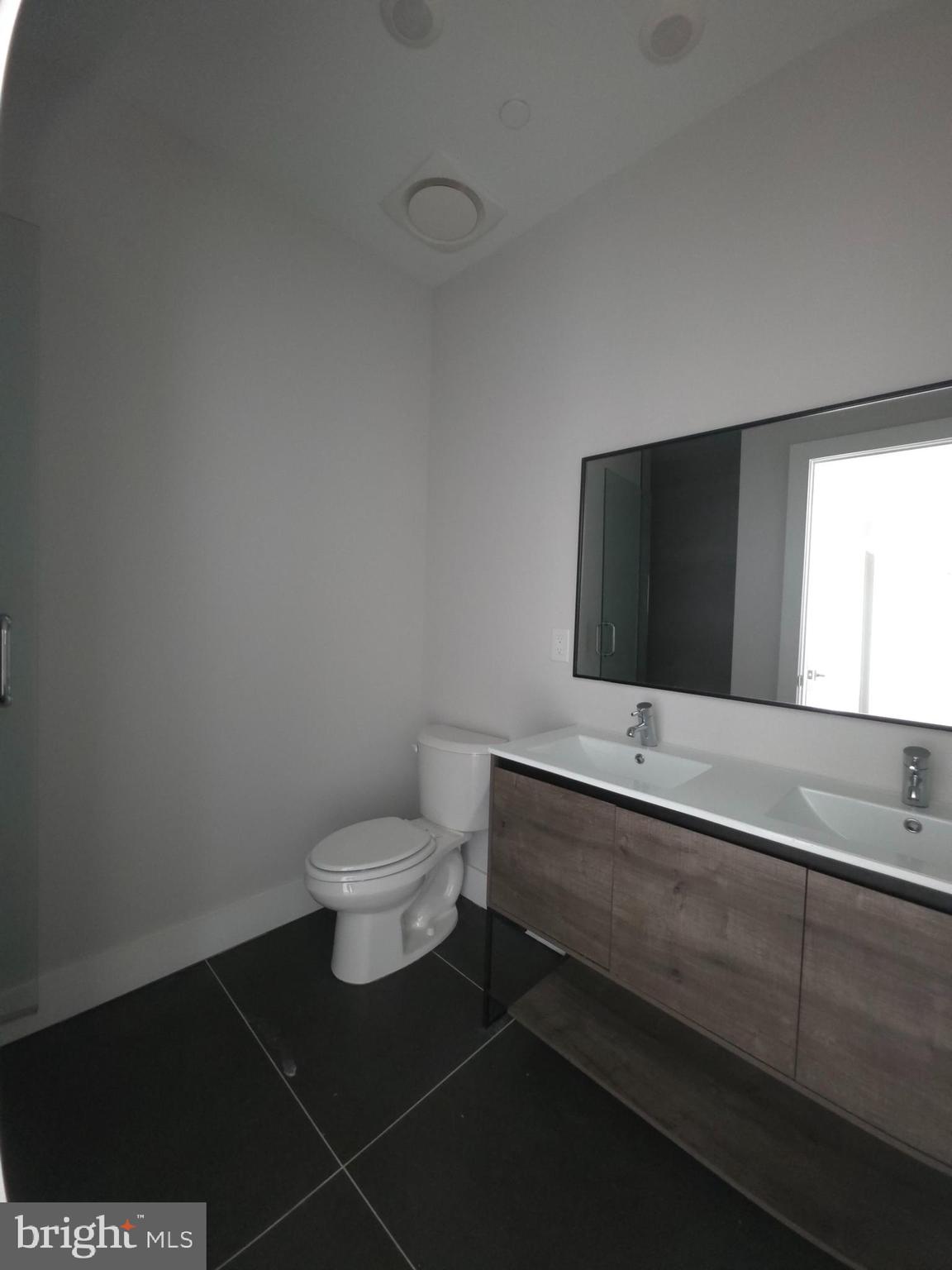 3503 Midvale Avenue, Unit 506 Philadelphia, PA 19129 - Photo 36 of 40 a bathroom with a toilet a sink and mirror
