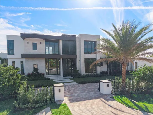 a front view of a house with garden and outdoor seating