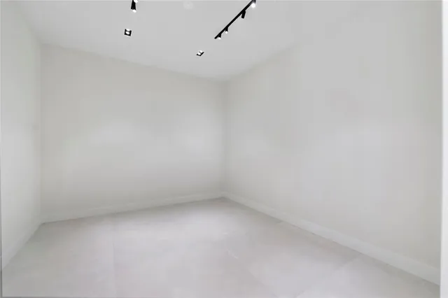 a view of empty room with floor to ceiling windows