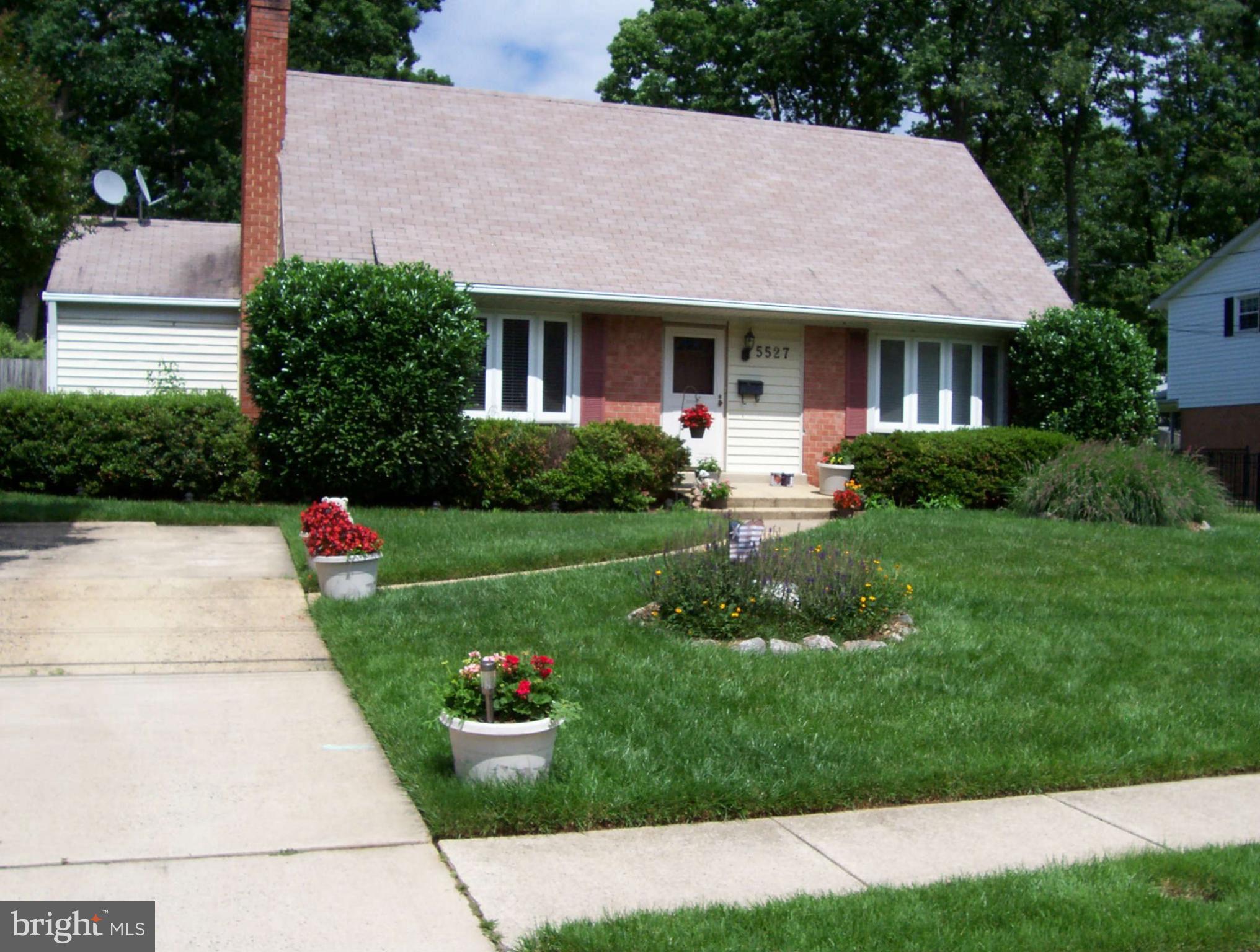 5527 Rolling Road Springfield, VA 22151 - Photo 3 of 27 a front view of a house with a yard and garage