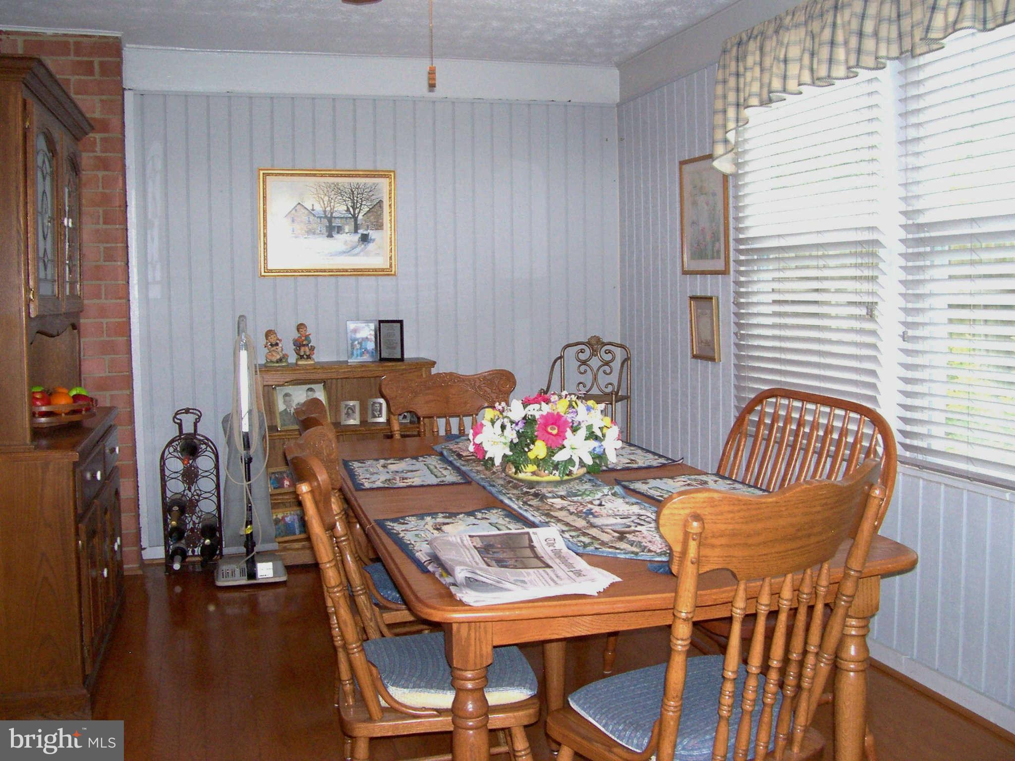 5527 Rolling Road Springfield, VA 22151 - Photo 22 of 27 a view of a dining room with furniture and wooden floor