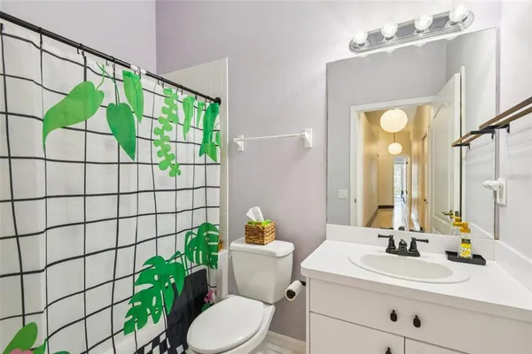 a bathroom with a sink mirror and toilet