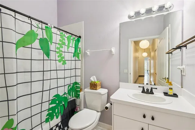 a bathroom with a sink mirror and toilet