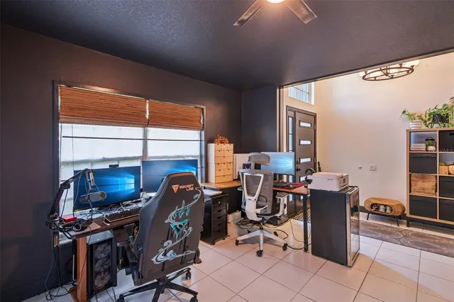 a view of a workspace with furniture and a window