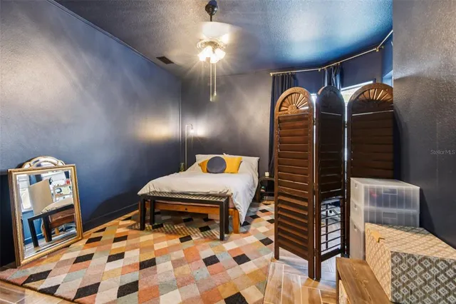 a bedroom with a bed and dresser