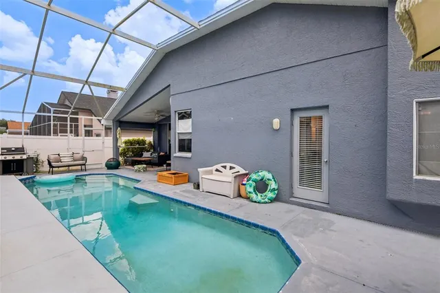 an aerial view of a house with a garden and swimming pool