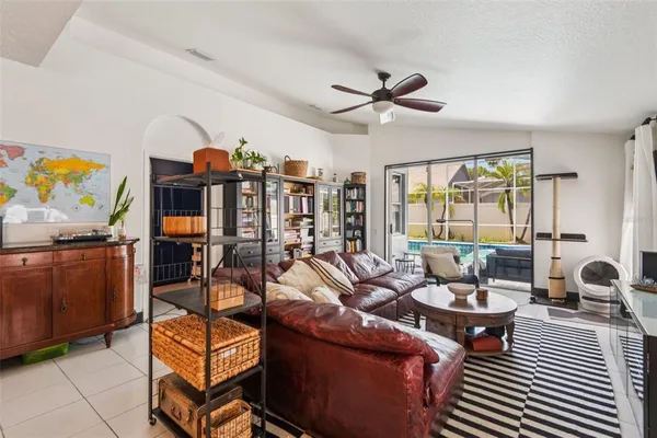 a living room with furniture a air conditioner and a window