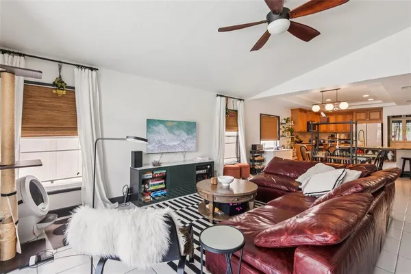 a living room with fireplace furniture and a flat screen tv